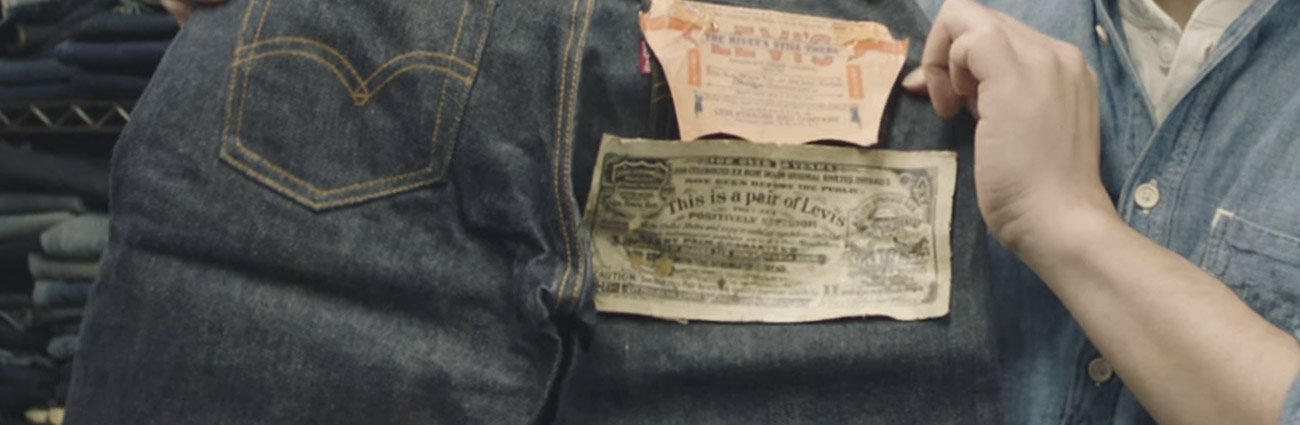 Levi jeans held up by worker showing original logo