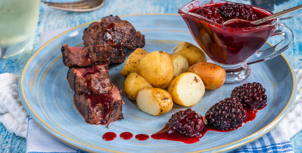 Pan-seared venison steaks with wild berry jus
