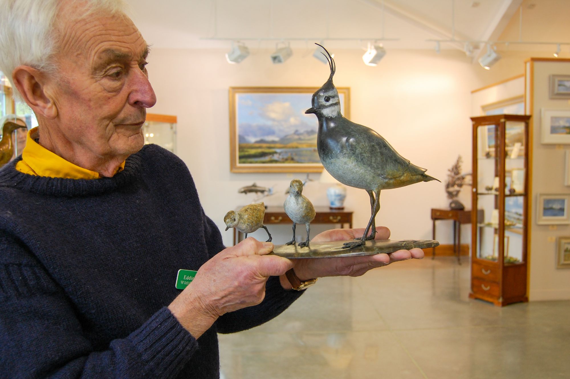 Eddie Hallam artist holding sculpture of lapwing and chicks