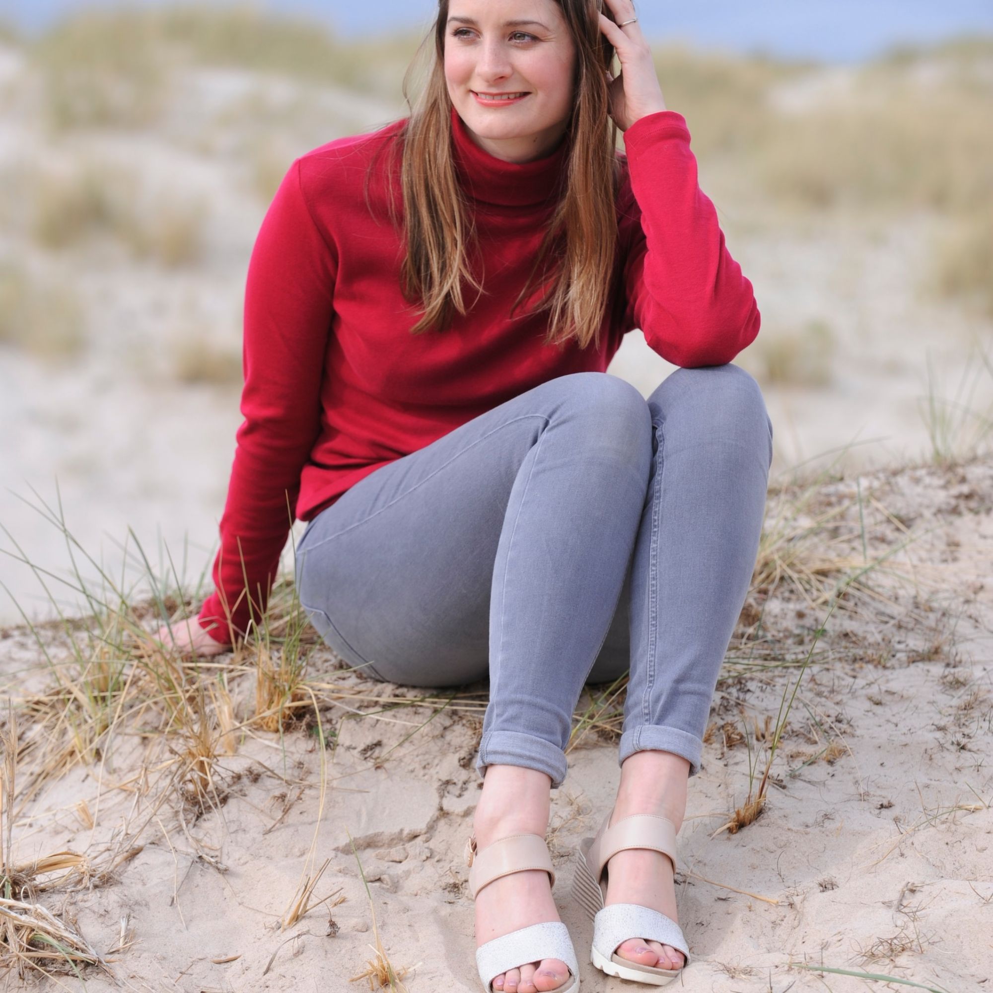 buyer wearing neutral sandals in sand beach