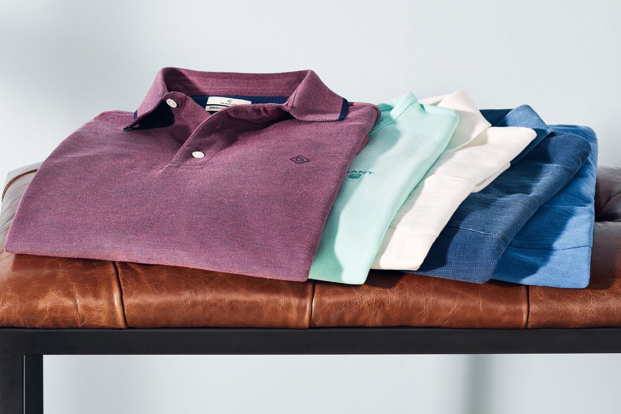 Gant Men's polo shirts folded on leather footstool